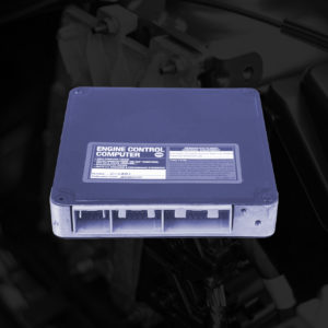 car engine control module part image with dark background