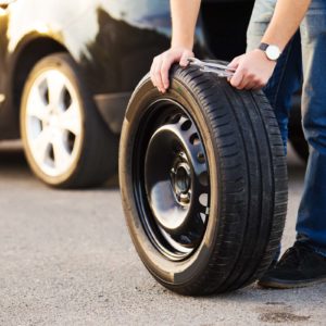 person with car tire replacement