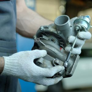 remanufactured turbocharger in the hands of auto mechanic