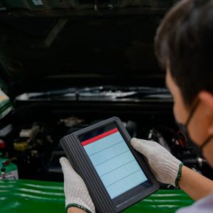 mechanic holding an obd scan tool