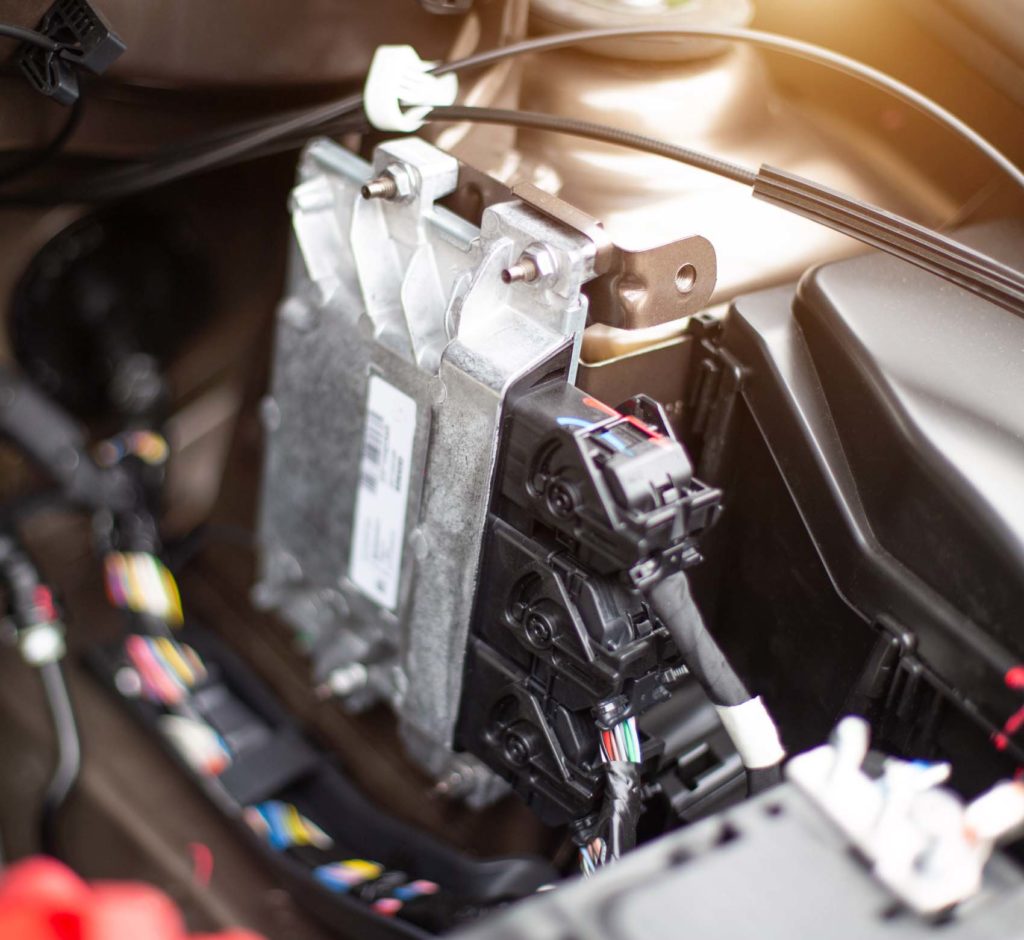 functioning car engine control module visible from car hood