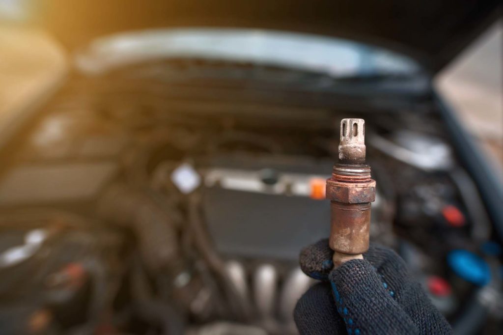 holding old oxygen sensor for older car