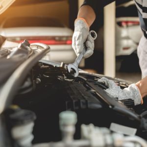 mechanic checking car underhood