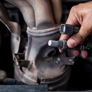 mechanic checks car oxygen sensor part