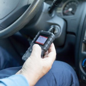 mechanic using an obd tool