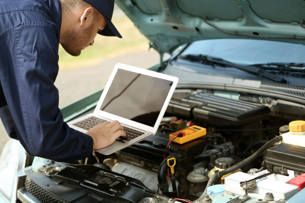 auto mechanic using computer diagnostics after getting p0690 code