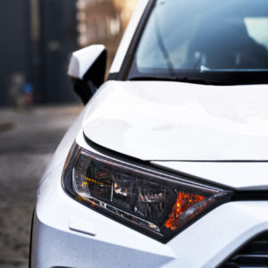 car sedan or coupe front close up with headlight visible