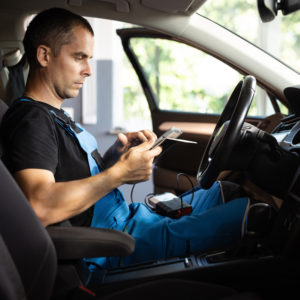 mechanic holding a trouble code scanner