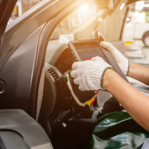 mechanic using a diagnostic trouble code scanner