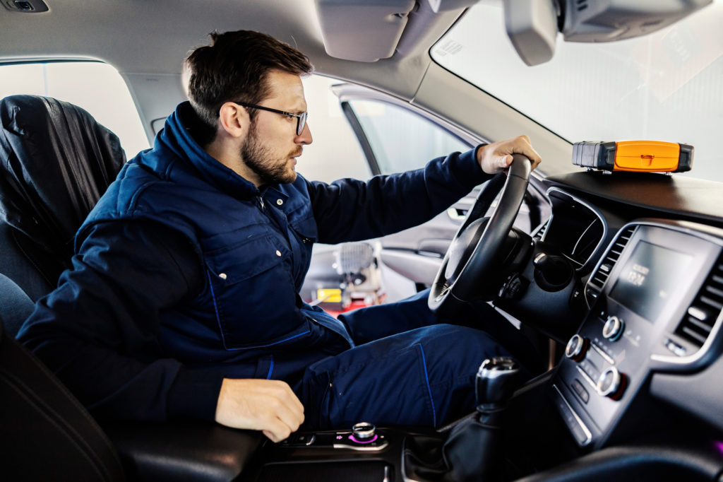 male mechanic inspects car steering wheel