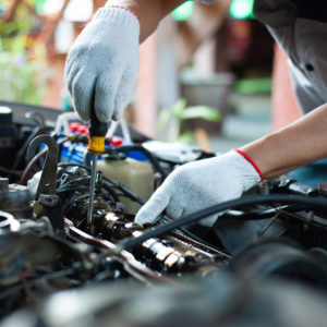 mechanic checking engine valve and camshaft