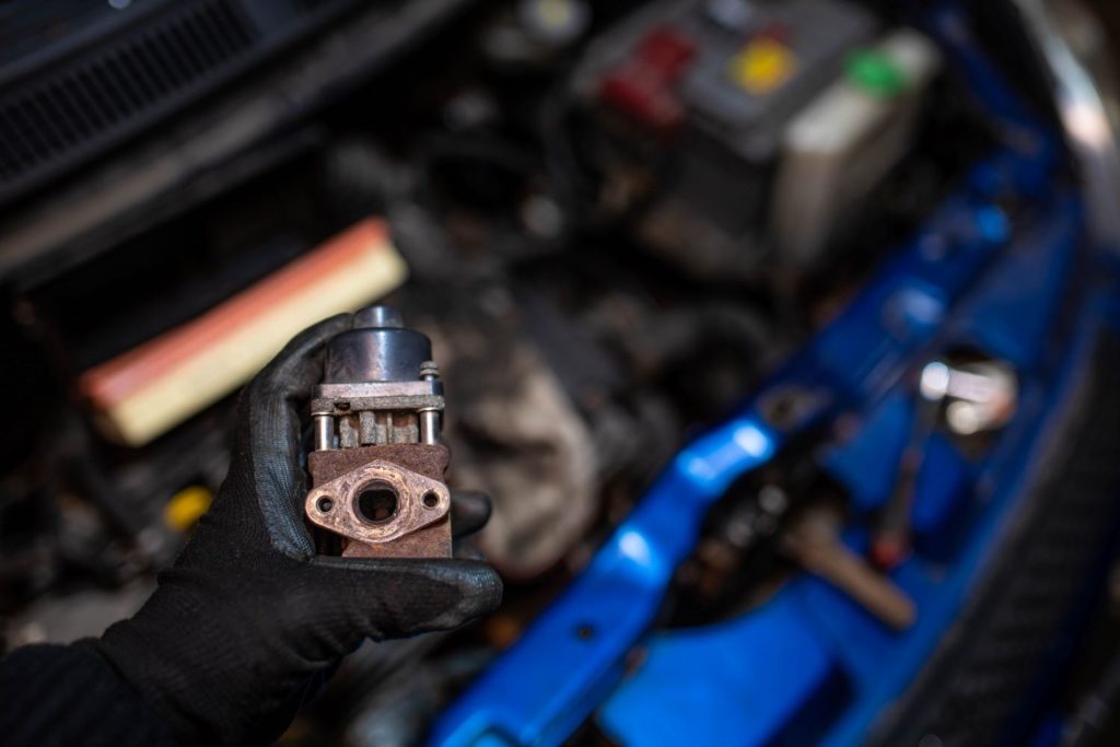 mechanic holding an egr valve