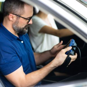 mechanic holding obd scan tool