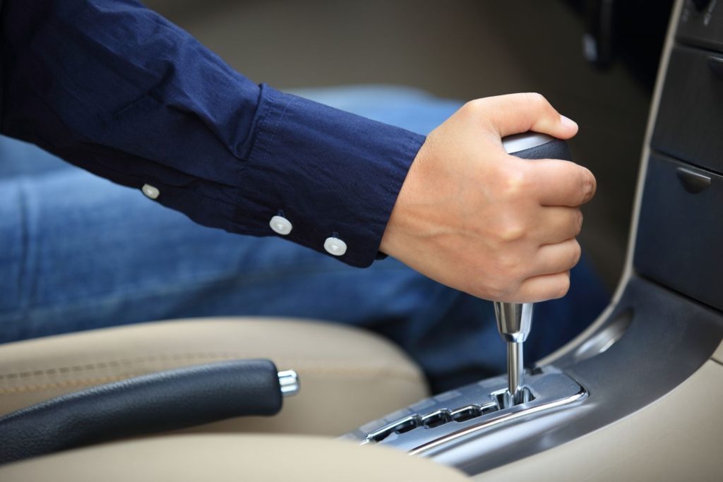 driver shifting an automatic transmission gear