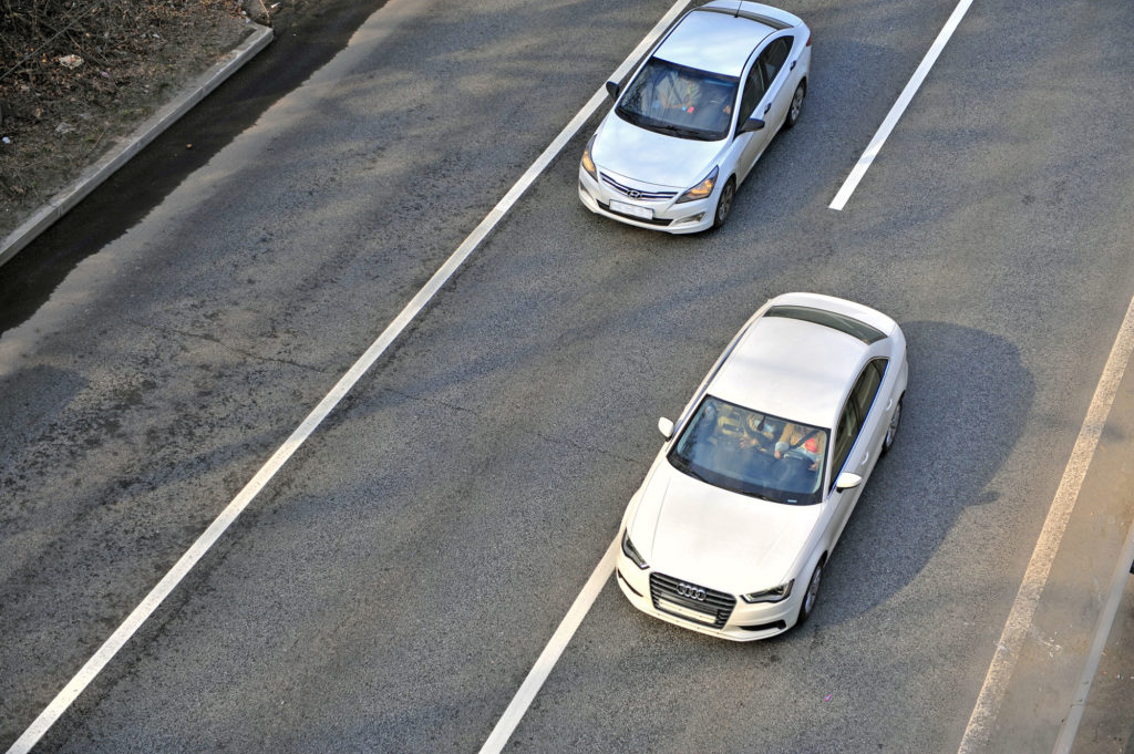 white cars traversing highway