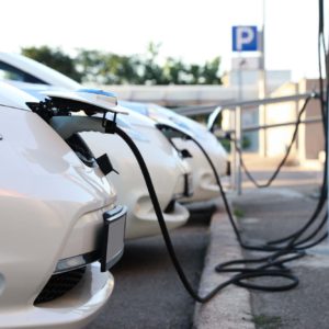 white electric vehicles at the charging station