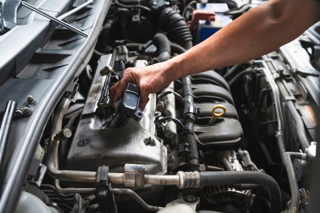 mechanic checking car engine