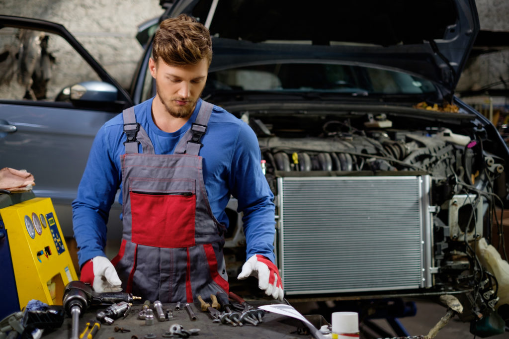 mechanic checking car airconditioning system