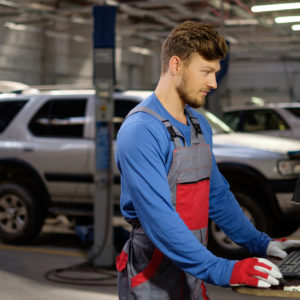 mechanic checks obd tool on computer