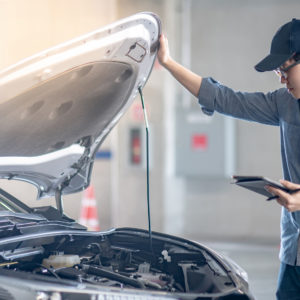 mechanic opens hood to check camshaft position sensor