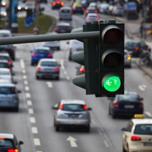 streetlight on go signal with cars moving