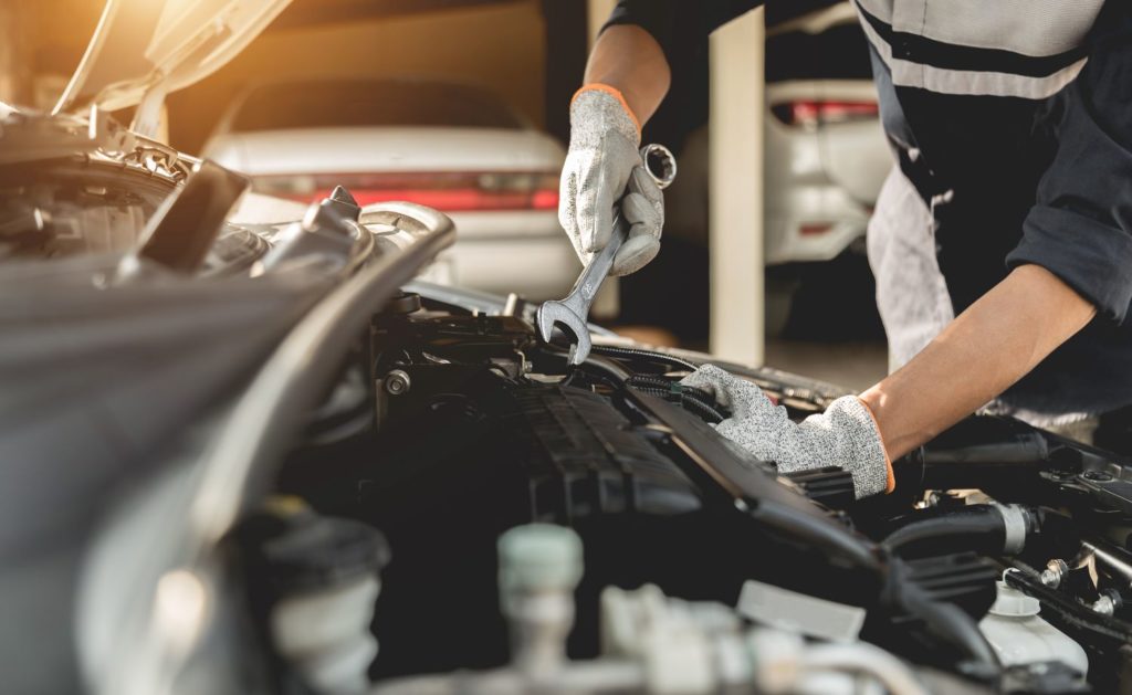 mechanic fixing a car engine