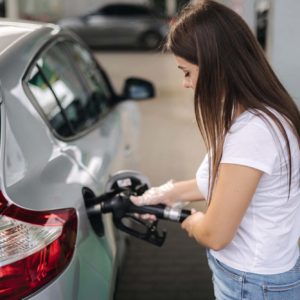 female driver refueling her car