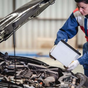 male mechanic planning to change car battery