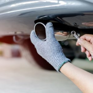 mechanic fixing a muffler