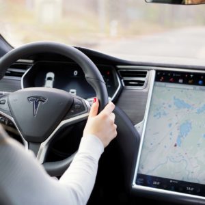 woman driving a tesla car