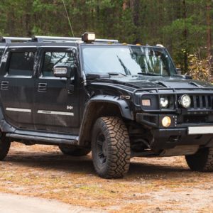 front view of a black hummer h2 in an offroad setting