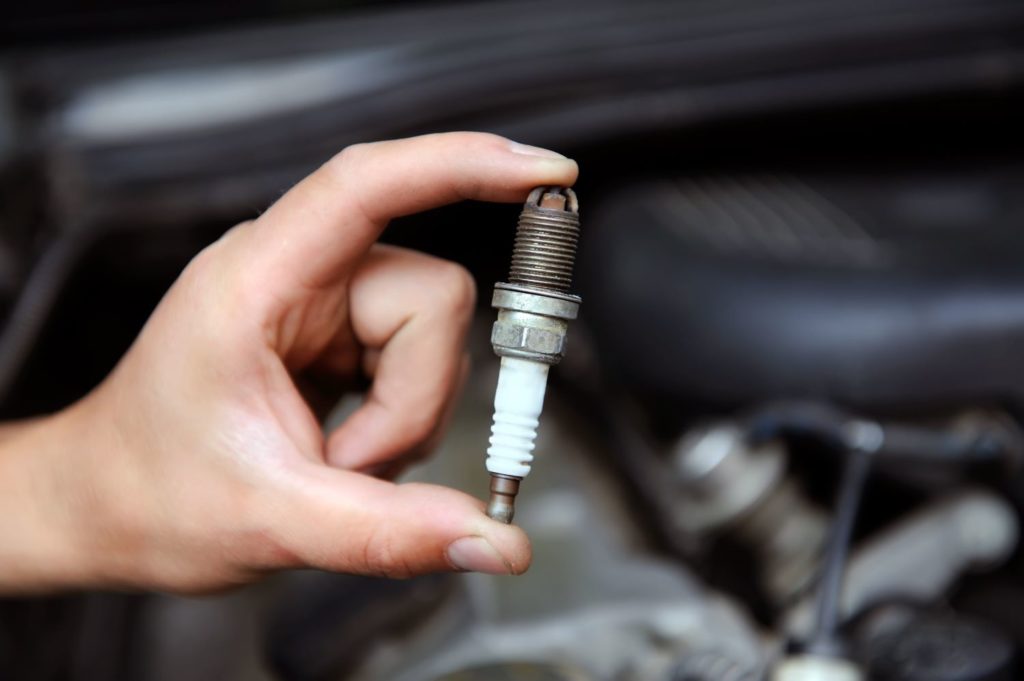 hand holding a new spark plug