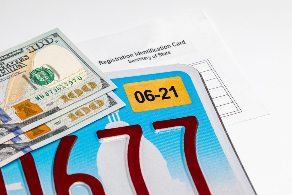 dollars, license plate, and registration identification card