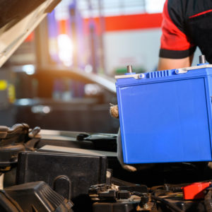 mechanic installing new car battery