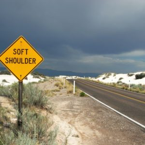 soft shoulder road sign in a desert road