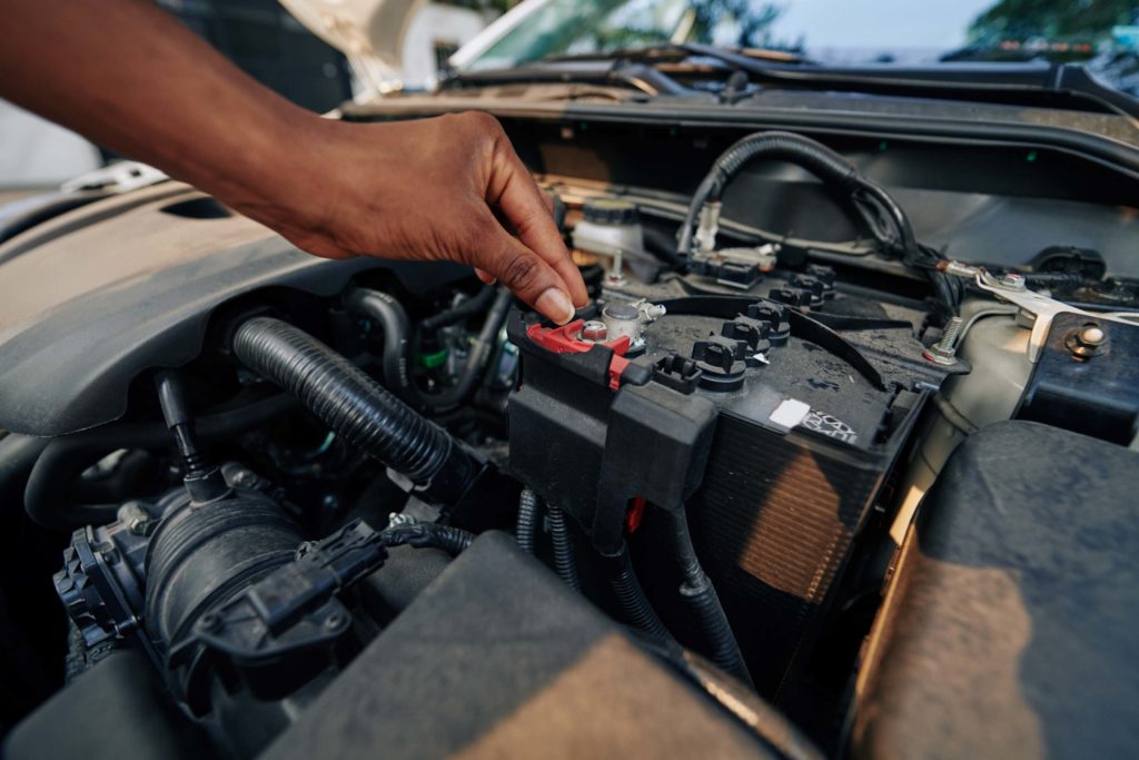 woman checking car old battery