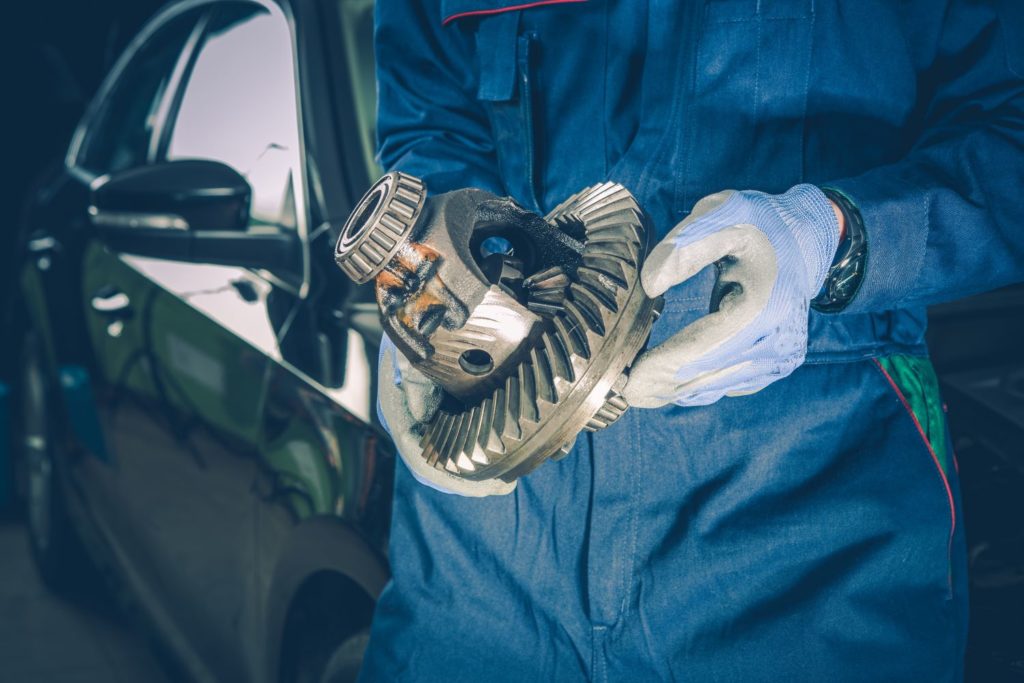 mechanic holding a differential and pinion seal