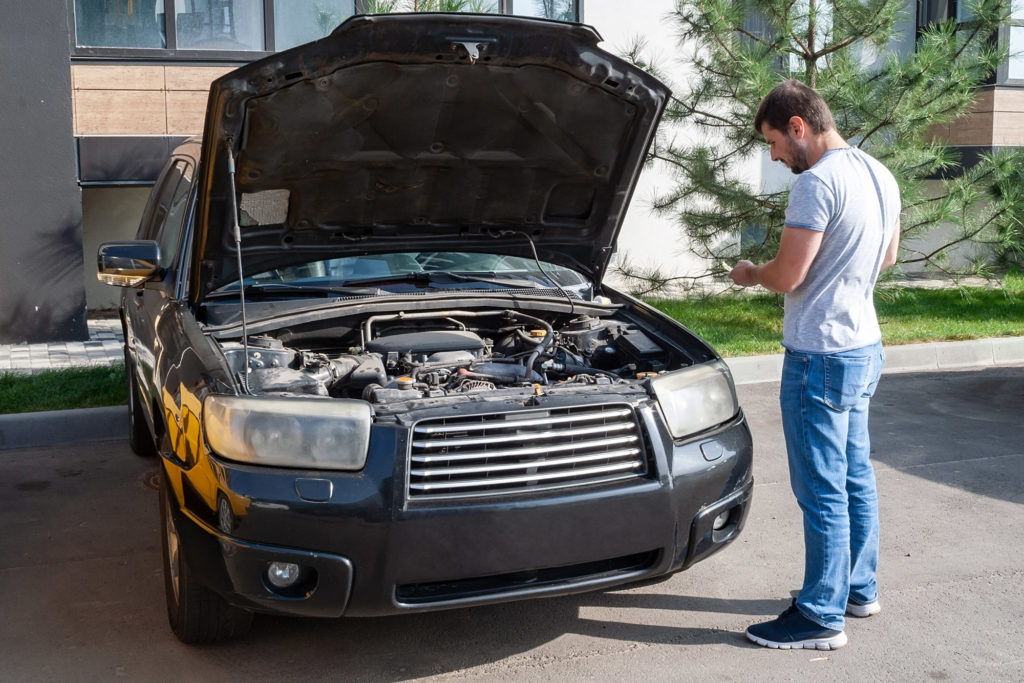 man checking the cost of car repair