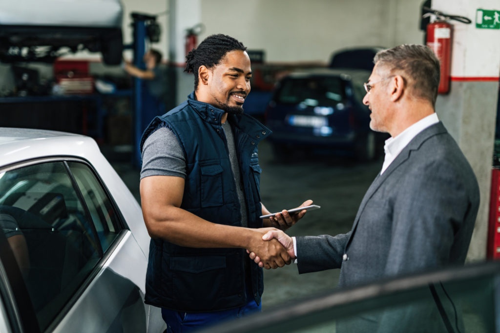 man talking to insurance representative about car