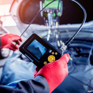 mechanic using a video to diagnose an engine