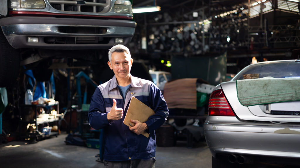 vehicle inspector giving a thumbs up after rebuilt car inspection