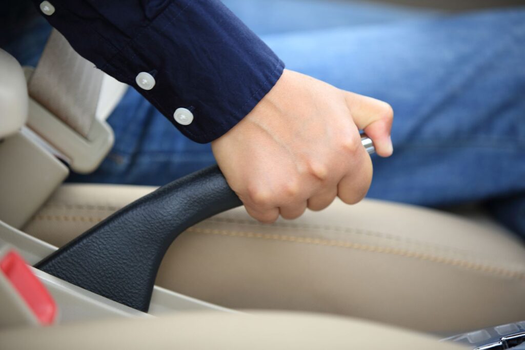 driver pulling the parking brake lever