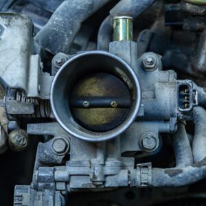 close up shot f a car throttle body with possible oil