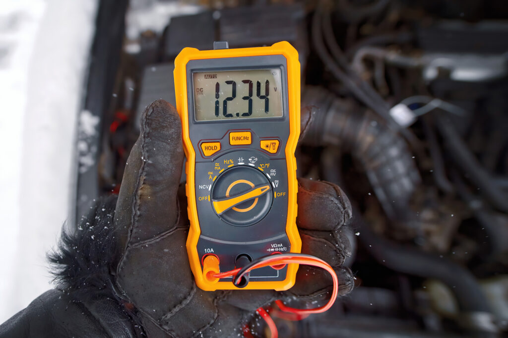 holding voltmeter to check grid voltage