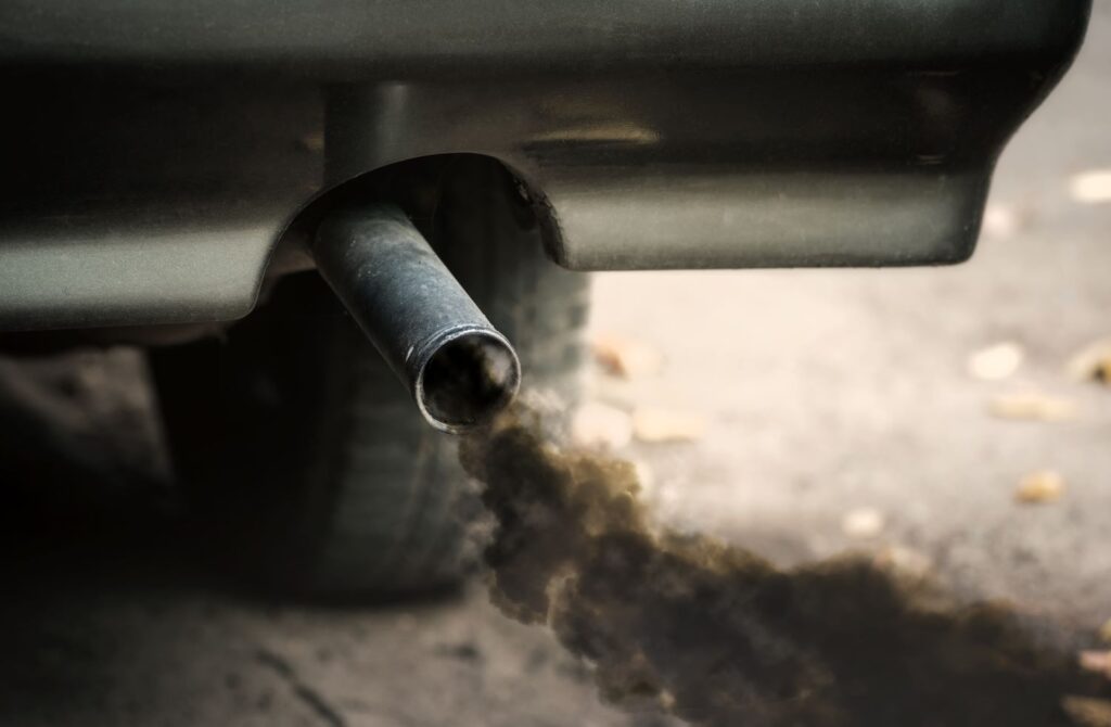 dark smoke coming out of a car tail pipe