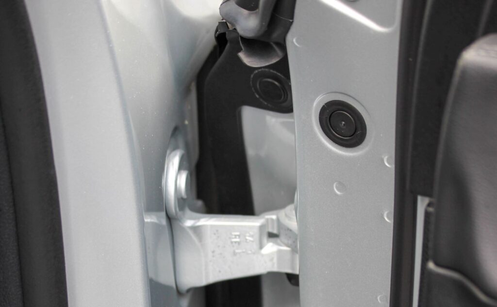 image of a door hinge and door jamb switch