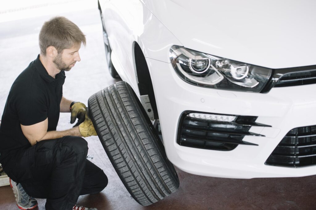 mechanic preparing to patch car tire