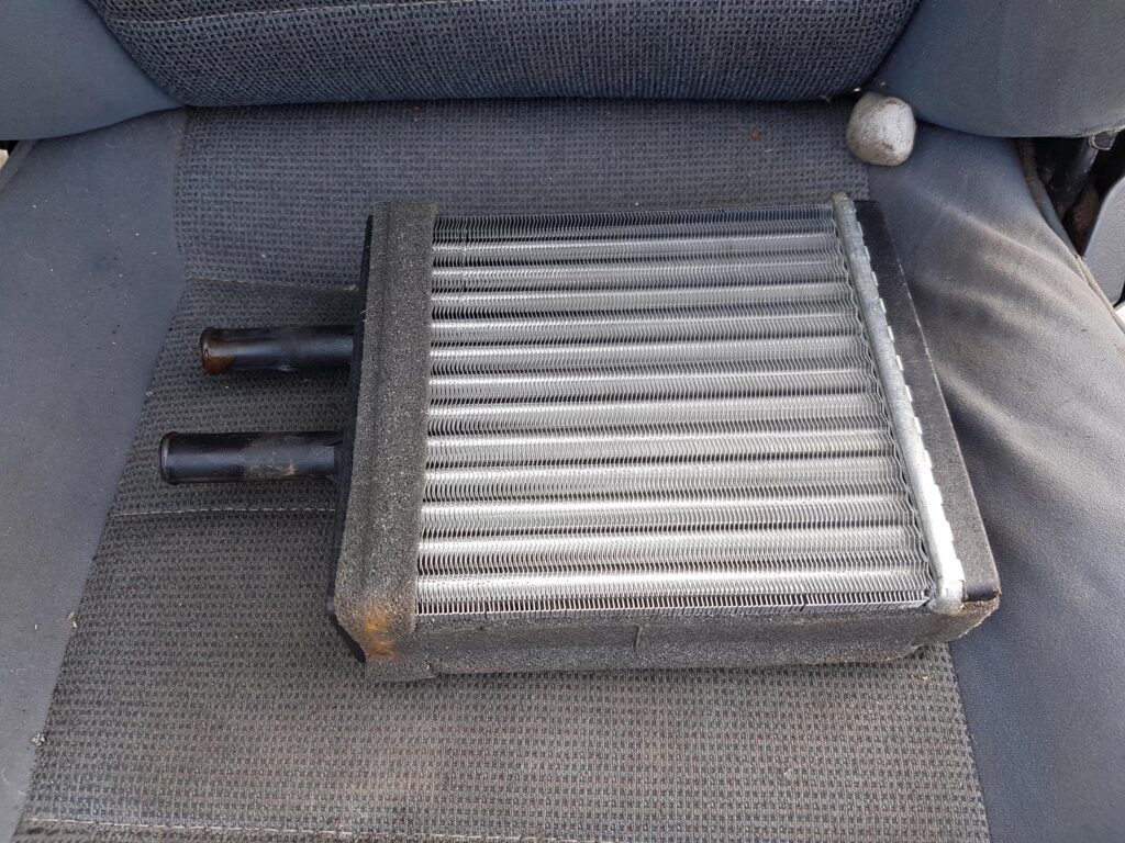 damaged heater core on top of car seat