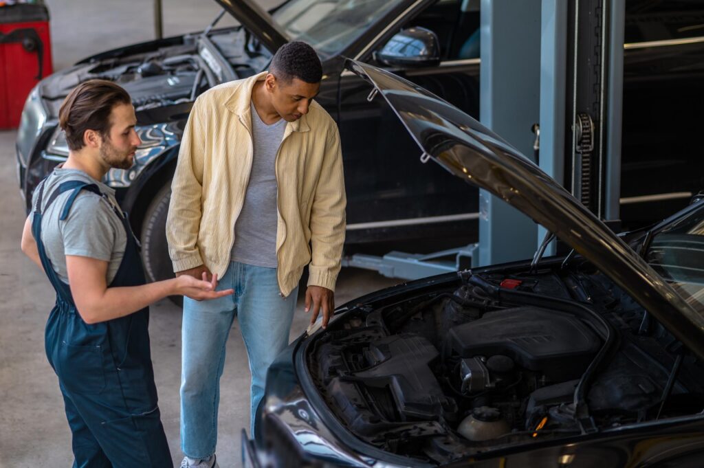 driver meets mechanic for car regular maintenance