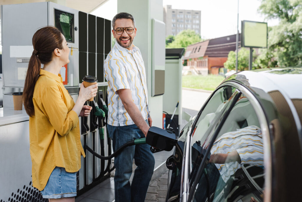 man and woman refueling car with quality fuel